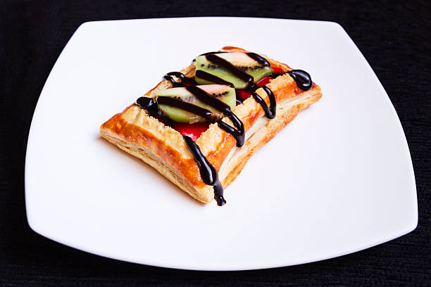 Sweet of puff pastry with fresh fruit and a base of jam of fruits with a touch of chocolate fudge adorning the dessert that next to the flavor of the kiwi and strawberry flavor achieved a espectaculalr