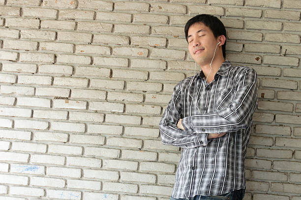 istock happy asian man with earphones 177819858
