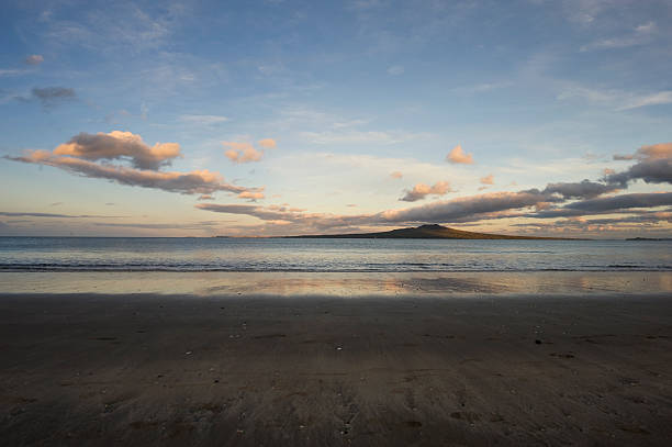 Rangitoto Island at low tide A view of Rangitoto Island at dusk and low tide, as seen from Takapuna beach on Auckland's North Shore. A wide-angle image. rangitoto island stock pictures, royalty-free photos & images