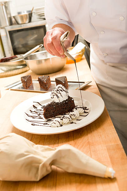 istock Male cook decorating slice of chocolate cake 177820200