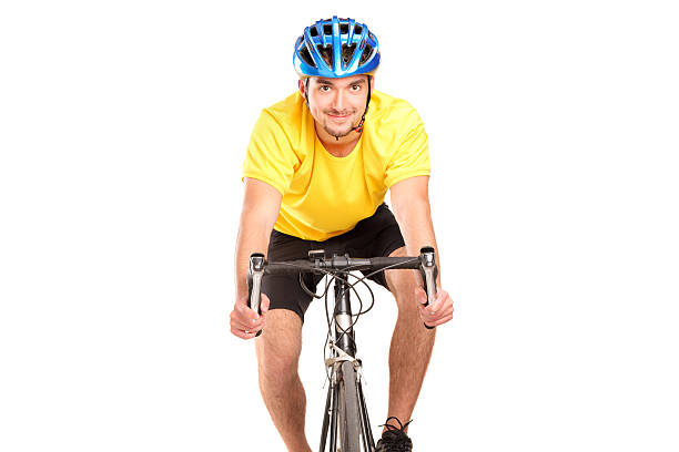 Fit woman on the exercise bike smiling at camera at the gym