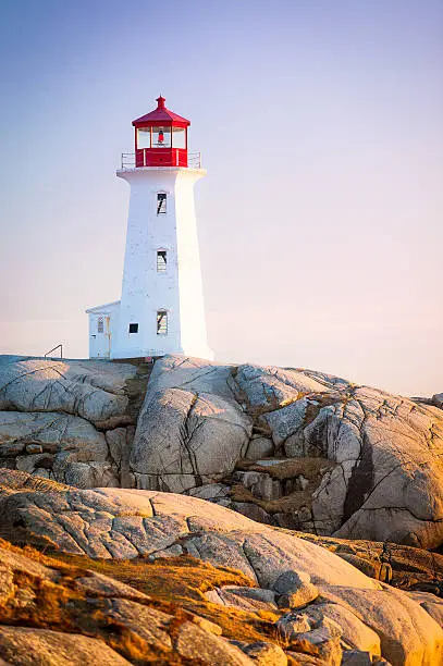 The iconic Peggys Cove (alternate spelling Peggy's Cove) lighthouse in Nova Scotia, Canada. The lighthouse sits on 415 million year old granite, part of the Nova Scotia batholith.