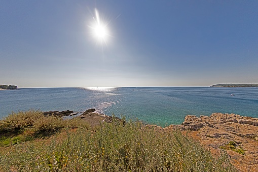 Picture of a deserted section of the Istrian Adriatic coast during the day in summer