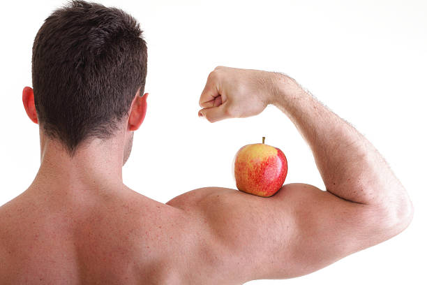 istock Athletic sexy male body builder holding red apple 177821760