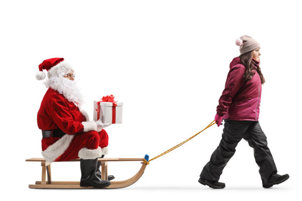 istock Girl pulling a sleight with Santa claus sitting and holding a present 1778230486
