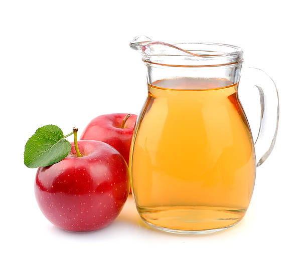 Arrangement of it her of apple juice with two apples Red apple and apple juice on a white background apple juice photos stock pictures, royalty-free photos & images