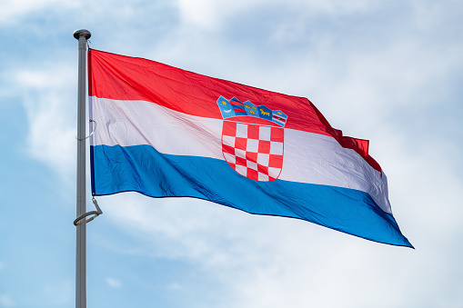 The national flag of Croatia waving in the blue sky