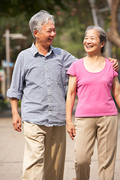 istock Senior couple walking in the park 177824476