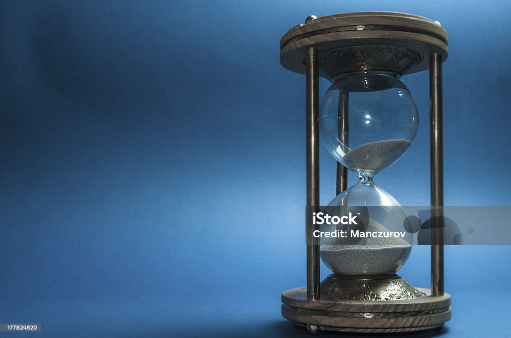 hourglass sandglass on blue background Abstract Stock Photo
