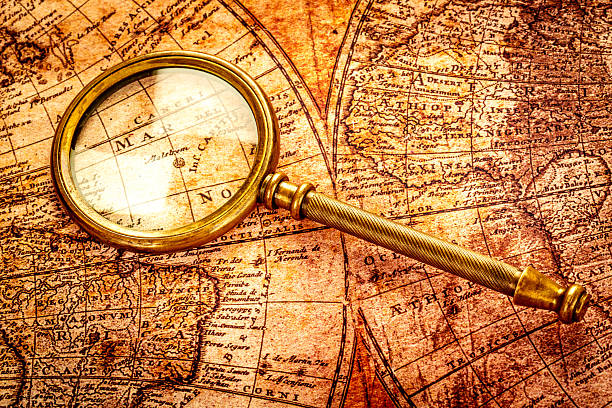 istock Vintage magnifying glass lies on an ancient world map 177825068