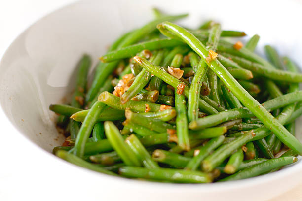 Green beans Spicy haricot vert green beans in a bowl. green bean stock pictures, royalty-free photos & images