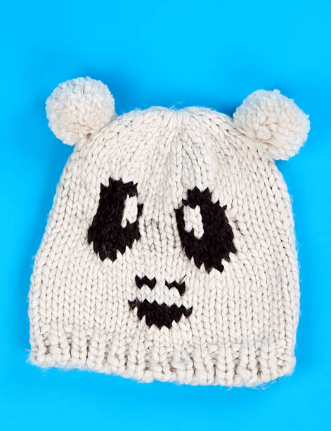 knitted wool hat with a pattern of little faces