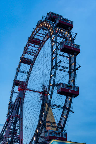 Giant ferris wheel against clear evening sky in Vienna, Austria. Giant ferris wheel against clear evening sky in Vienna, Austria. low viewing point stock pictures, royalty-free photos & images