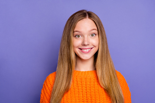 Photo of adorable sweet cheerful girl beaming toothy smile good mood isolated on violet color background.