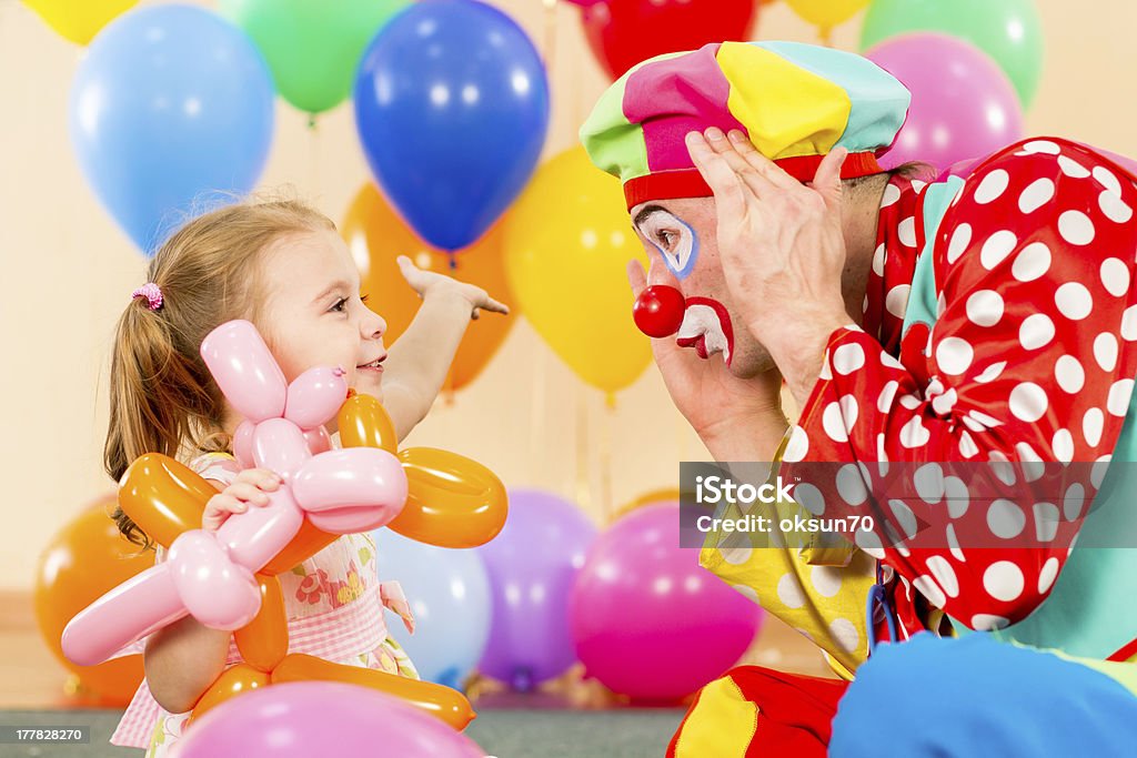 happy child girl and clown playing on birthday party Clown Stock Photo