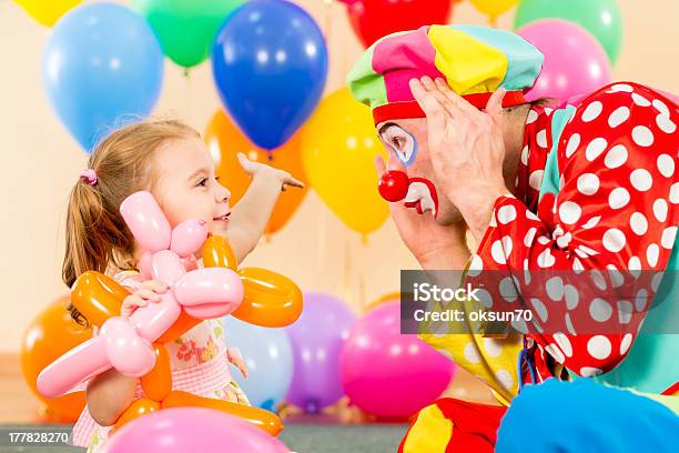 Happy Child Girl And Clown Playing On Birthday Party Stock Photo - Download Image Now