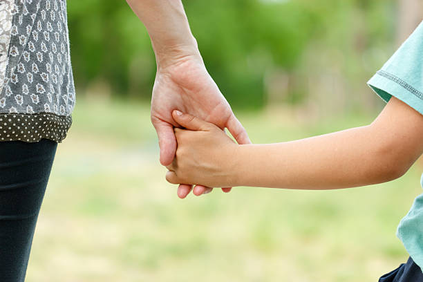 istock Mother holding a hand of her son 177829537