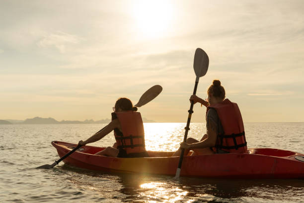 istock Happy group kayaking at sunset by the sea 1778296168