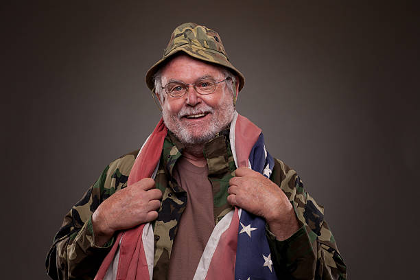 Smiling Vietnam Veteran with American flag stock photo