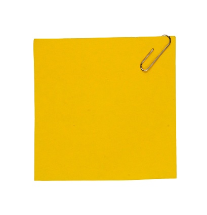 yellow note paper with clip isolated