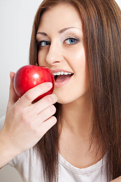 istock woman going to eat red apple 177830677