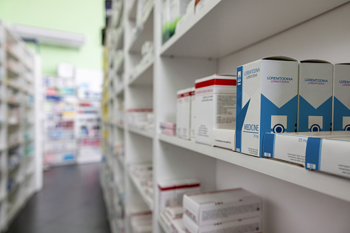 Empty pharmacy with prescription medicines on the shelves - pharmaceutical industry concepts