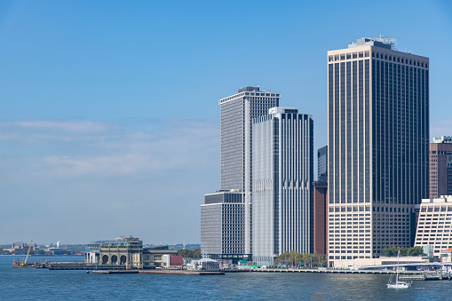 Panoramic view over the East River towards the Financial District and The Battery at the southern tip of Manhattan, New York City, NY, USA against a clear blue sky