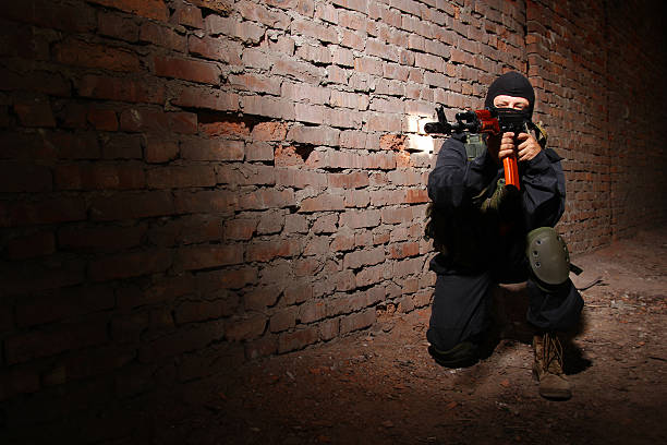 istock Armed soldier in black mask targeting with a gun 177832071