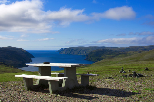 Summer view of Mageroya, Norway. There are pinic table and chair overlooking blue fjords and hills, it's near by northkapp(north cape).                                                               
