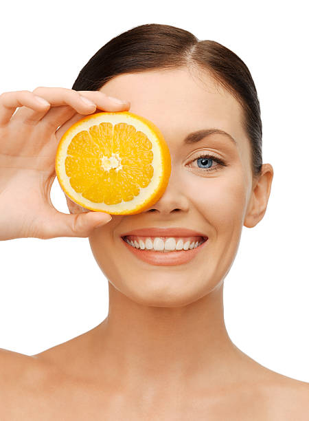 istock woman with orange slice 177832777
