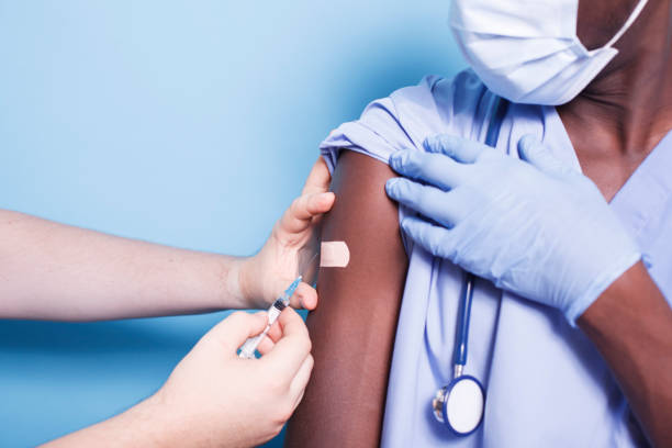 istock Doctor vaccinating black male nurse 1778330055