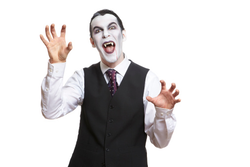 Man in dracula fancy dress costume on white background