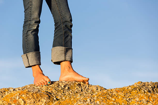 istock Woman's Bare Feet Standing on a Rock 177834039