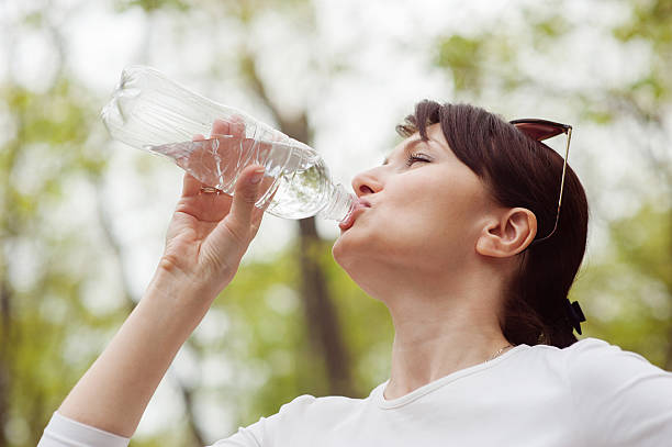 istock Woman drinks water from a bottle 177834315