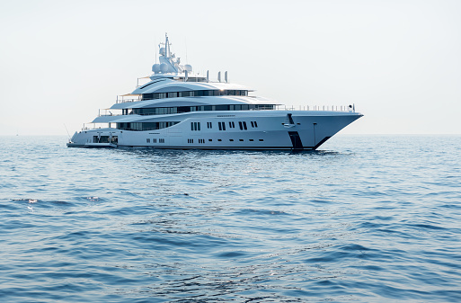 A large luxury private motor yacht under way sailing on the sea
