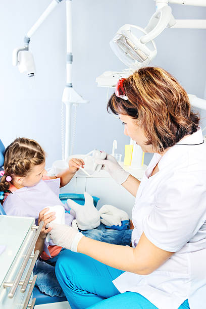 istock Dentist showing toy teeth 177834574