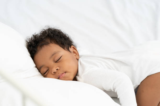 istock black african american baby sleeping on a white mattress. 1778351882