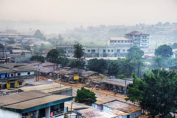 Big African city at dawn Big African city at dawn with typical tin roofs and people already out in the streets. More Africa photos: http://tonytremblay.com/sylvie/afrique.jpg cameroon photos stock pictures, royalty-free photos & images
