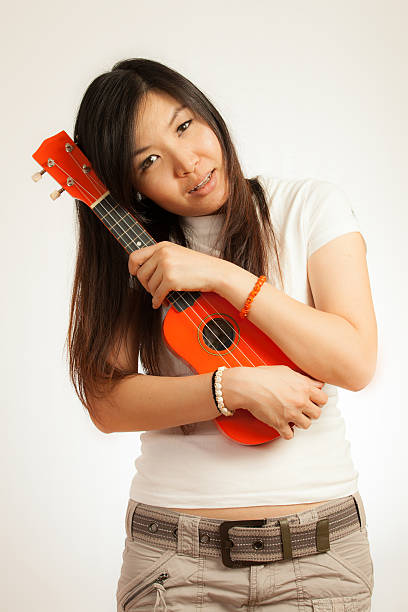 istock Aian woman enjoy her Ukulele 177835472