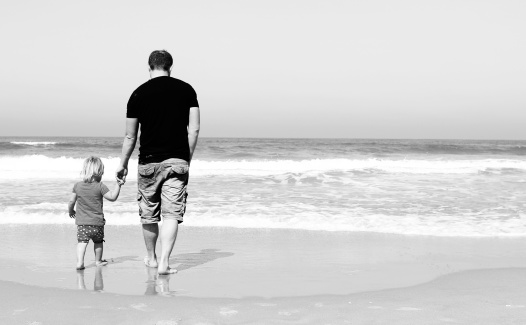father and daughter on the beach. Black and white photo. 