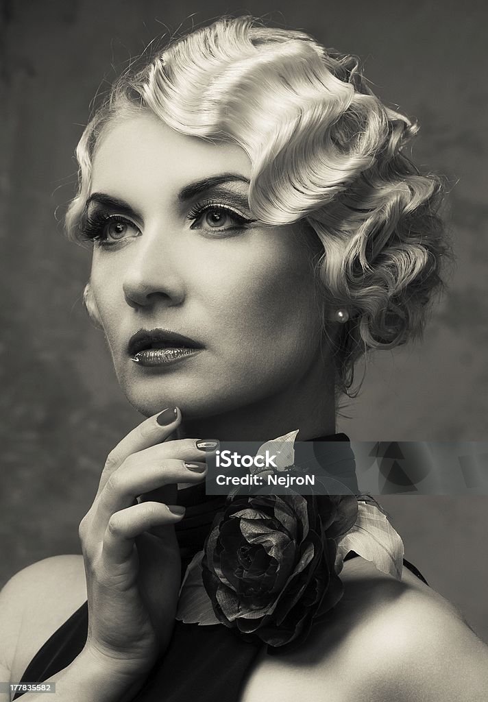 Monochrome portrait of elegant blond retro woman Monochrome portrait of elegant blond retro woman  in dress with beautiful rose flower Adult Stock Photo