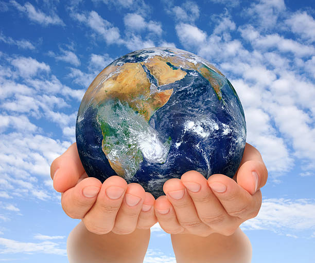 Hands of woman holding globe, Africa and Near East stock photo