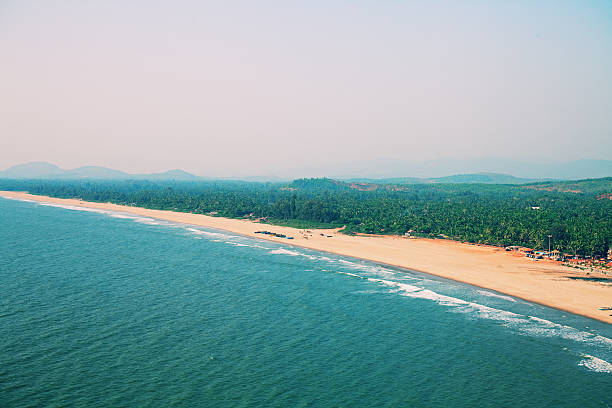 Taken this picture of Konkan beach in India where villagers walking on the street and there is a para glider flying in the sky. It was evening high tide was approaching and sea was getting rough. On right side are villagers in their daily course who lives nearby.