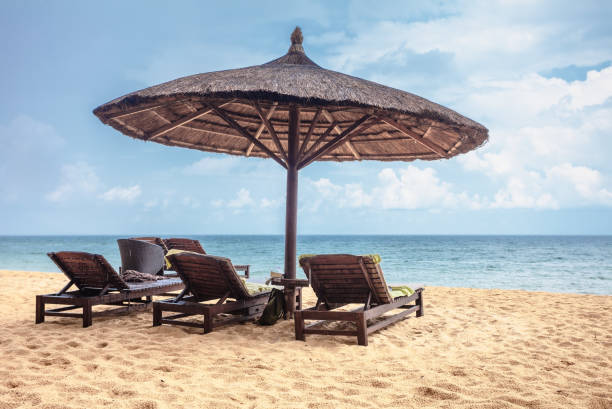 istock Wooden chairs and umbrellas on white sand beach 1778364992