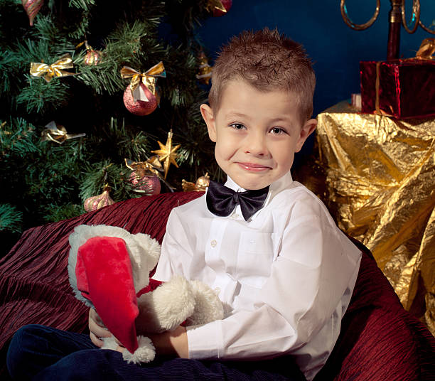 Little boy near Christmas tree stock photo