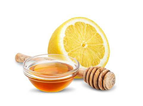 Lemon and honey isolated on white background. Natural remedy for cold, cough and sore throat