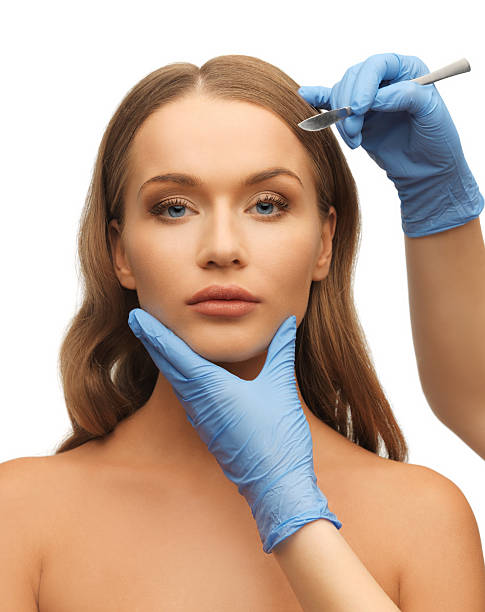 istock woman face and beautician hands 177837401