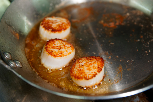 Scallops being seared on hot pan