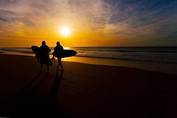 istock silhouette of 2 surfers 177837601