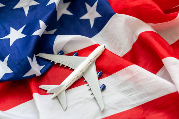 istock Toy plane with american flag on grey background. Top view 1778376073